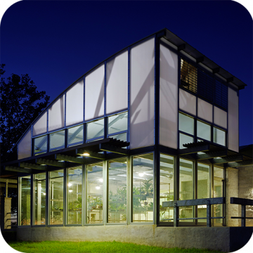 The second story of an office building has a curved wall constructed with gray Skypoly.